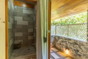 a glass door leading to a shower in a bathroom at Our Beachfront Bungalow in Puerto Viejo +18 photos