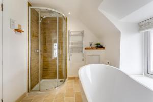 a bathroom with a shower and a bath tub at 2 Bed in Strath oc-s44223 in Gairloch +23 photos