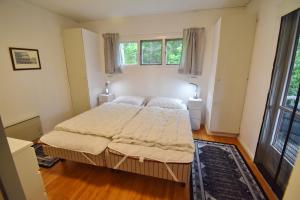 a bedroom with a bed and two windows at "Kiatorp" in Fagerhult
