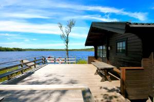 a wooden dock with a bench on a lake at "Kiatorp" in Fagerhult