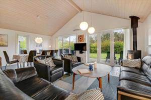 a living room with leather couches and a table at C11331-Tarm-Brombaervej-5 in Tarm
