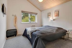 a bedroom with a large bed and a window at C11331-Tarm-Brombaervej-5 in Tarm