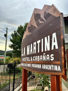 a sign for the la marina hotel and cabanas at La martina in Junín de los Andes