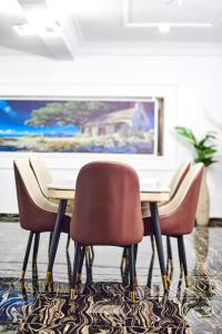 a group of chairs around a table in a room at Lodgeselect in Ibadan