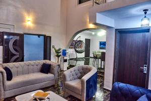 a living room with a couch and a chair at Lodgeselect in Ibadan
