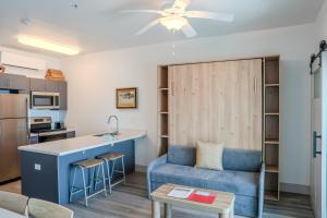 a living room with a blue couch and a kitchen at Driftwood Inn in Mexico Beach