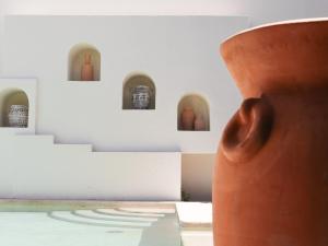 a large orange vase in a room with stairs at La Palma Beachfront Hotel Boutique in Cancún