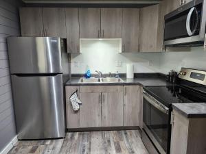 a kitchen with a stainless steel refrigerator and a sink at TeePee Room 17- Full Kitchen in Roscommon