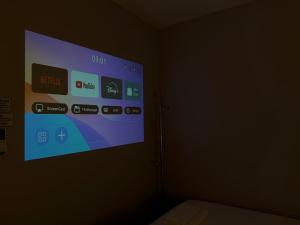 a projection screen on a wall in a dark room at Soulstay Bangkok in Bangkok