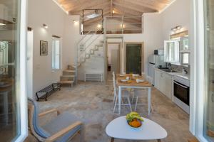 a kitchen and living room with a table and chairs at Amaranthus house in Longós