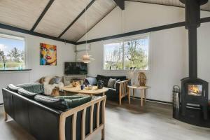 a living room with a couch and a fireplace at C11704-Hemmet-Rylevaenget-33 in Hemmet