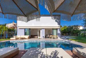 a villa with a swimming pool and a house at House Serenity in Njivice