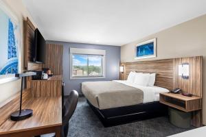a hotel room with a bed and a television at Quality Inn Ponca City in Ponca City