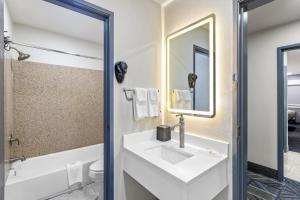 a bathroom with a white sink and a mirror at Quality Inn Ponca City in Ponca City +25 photos