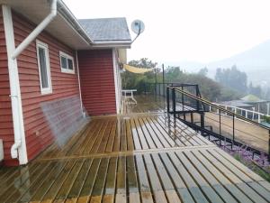 a deck on the side of a house at Oceana Suites Limache con piscina in Limache