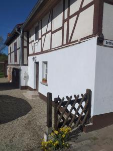 a white and brown building with a wooden fence at Alt Dwinge in Zwinge