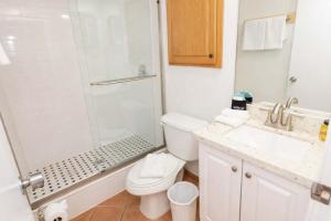 a bathroom with a shower and a toilet and a sink at EZ Beach Access Great Family Condo SpaceX view in South Padre Island