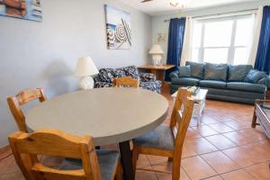 a living room with a table and chairs and a couch at EZ Beach Access Great Family Condo SpaceX view in South Padre Island