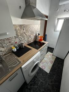 a kitchen with a sink and a washing machine at Modern & Comfortable Apartment in Tenerife South in Guargacho