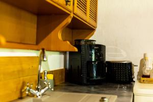 a kitchen counter top with a coffee maker on it at DejaView Casa Veche in Rogojel +27 photos