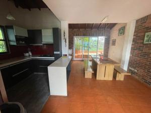 a kitchen with a counter in the middle of it at Finca Los Pony Girardota Antioquia in Girardota