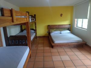 a bedroom with two bunk beds in a room at Finca Los Pony Girardota Antioquia in Girardota +18 photos