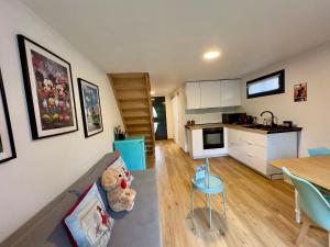 a living room with a teddy bear sitting on a couch at Au Charme De Bussy - Maison proche Disney avec terrasse et parking in Bussy-Saint-Georges