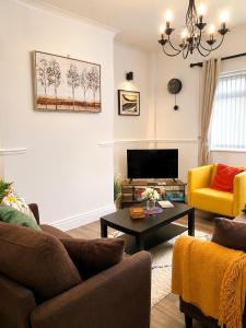 a living room with a couch and a table at Ushaw HillTop View-Suburban Free Parking Ideal for Work-Stays & Families in Ushaw Moor