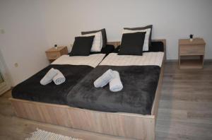 a large bed with two slippers on top of it at Elma in Kampor