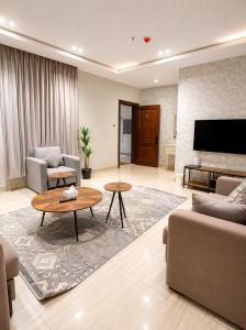 a living room with a couch and a table at Lovely Residence in Al Khobar