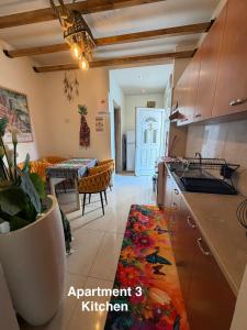 a kitchen and living room with a table and a counter at Errik Luxury House in Faliraki
