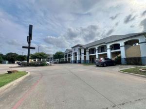 a large building with a cross in the middle of a street at Century Inn in Dallas