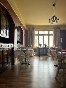 a dining room with tables and chairs and a chandelier at Auberge La Seigneurie in Matane