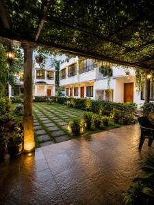 a courtyard of a building with plants at Morjim Pride Hotel with Swimming Pool near Morjim Beach in Morjim