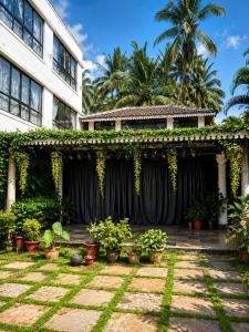 a house with a black curtain in a yard at Morjim Pride Hotel with Swimming Pool near Morjim Beach in Morjim