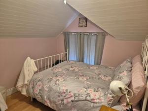 a small bedroom with a bed with flowers on it at Cottage on the hill in Carlow