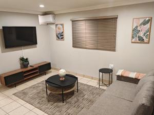 a living room with a couch and a flat screen tv at 18 on Asbestos in Nelspruit