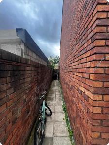 a bike parked next to a brick wall at Double Room with attach Bathroom in London