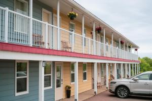 a car parked in front of a building at Bouctouche Bay Inn in Bouctouche