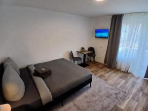 a room with a bed and a table with chairs at City Hub Room 22 - mit Balkon - Coffee for free - in Karlsruhe