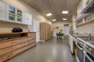 a large kitchen with wooden cabinets and a sink at C11694-Hemmet-Klydevaenget-1 in Hemmet