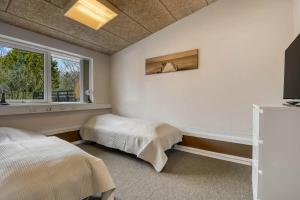 a bedroom with a bed and a window at C11694-Hemmet-Klydevaenget-1 in Hemmet