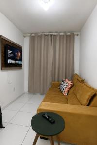 a living room with a couch and a table at Apto Completo São João com Garagem e Piscina in Campina Grande