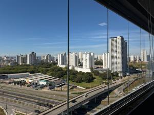 a view of a city with a highway and buildings at Flat Red Sorocaba - Blue in Sorocaba