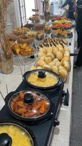 a buffet with many different types of food on a table at Samba Angra dos Reis in Angra dos Reis