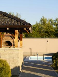 a building with a swimming pool with a roof at Muzzle House in Knić +1 photo