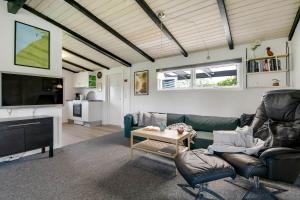 a living room with a couch and a tv at C11348-Tarm-Laksestien-3 in Tarm