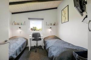 two beds in a room with a desk and a chair at C11348-Tarm-Laksestien-3 in Tarm