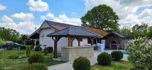 a house with a gazebo in a yard at Muzzle House in Knić