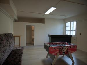 a room with a table in the middle of a room at Margaráta Vendégház in Soltvadkert